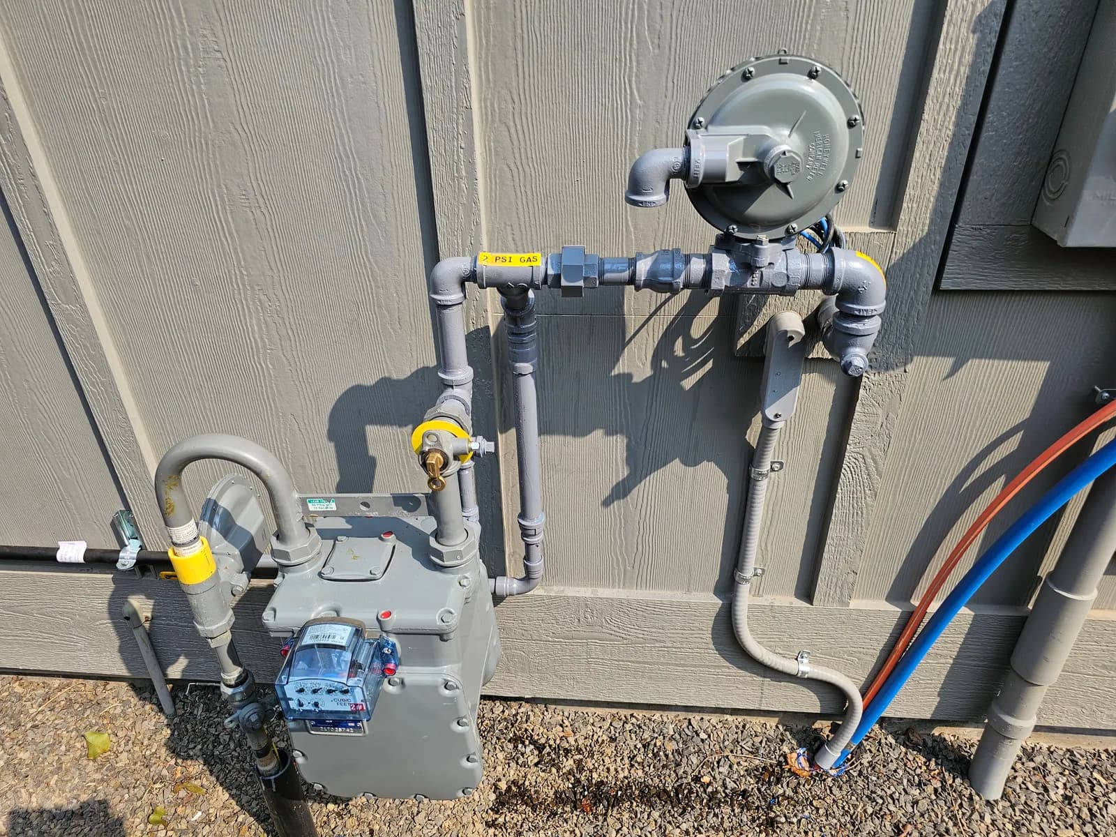 Natural gas meter with regulator, shutoffs, and labeled gas piping