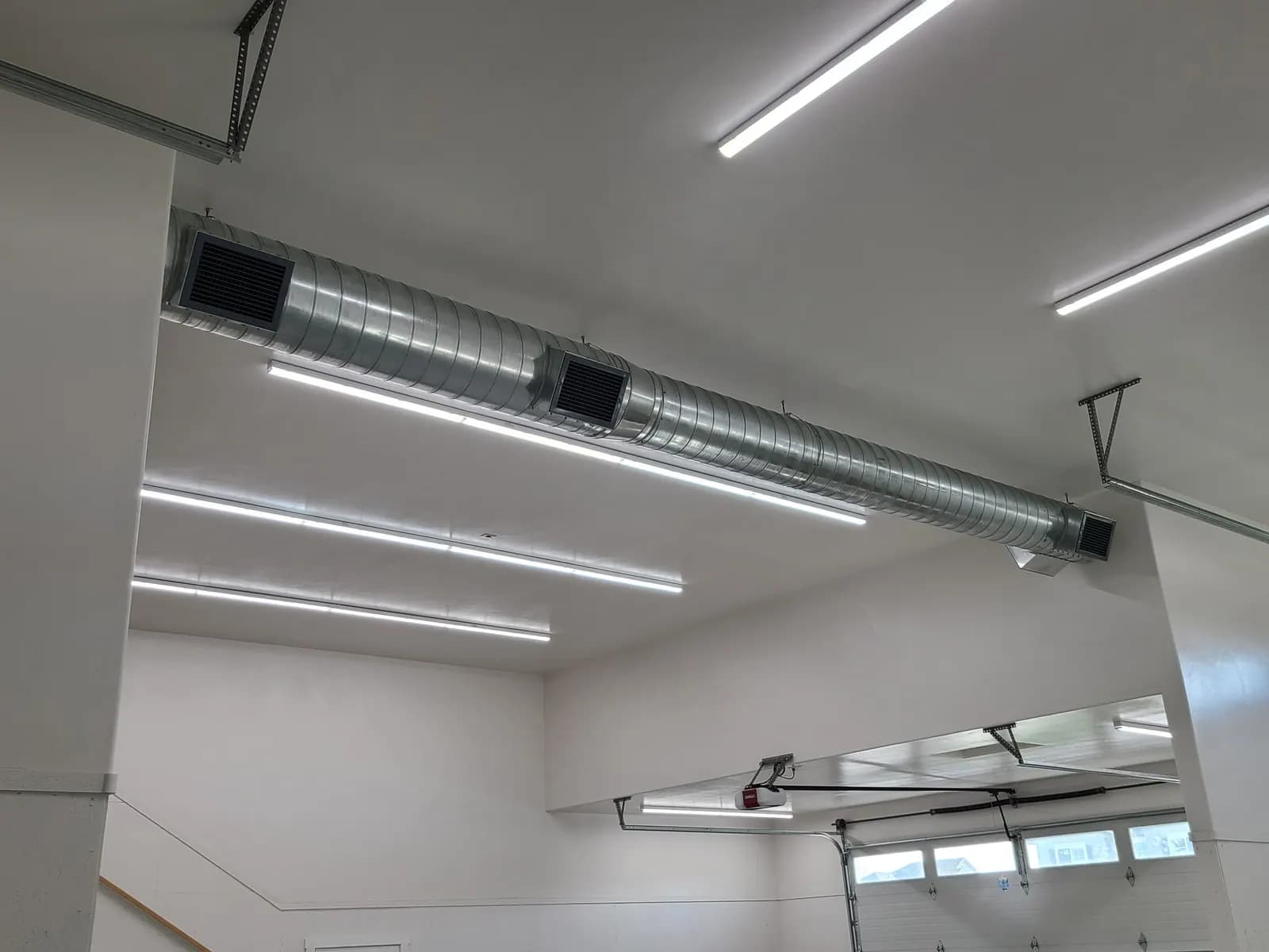Sheet metal ductwork installed in a shop ceiling