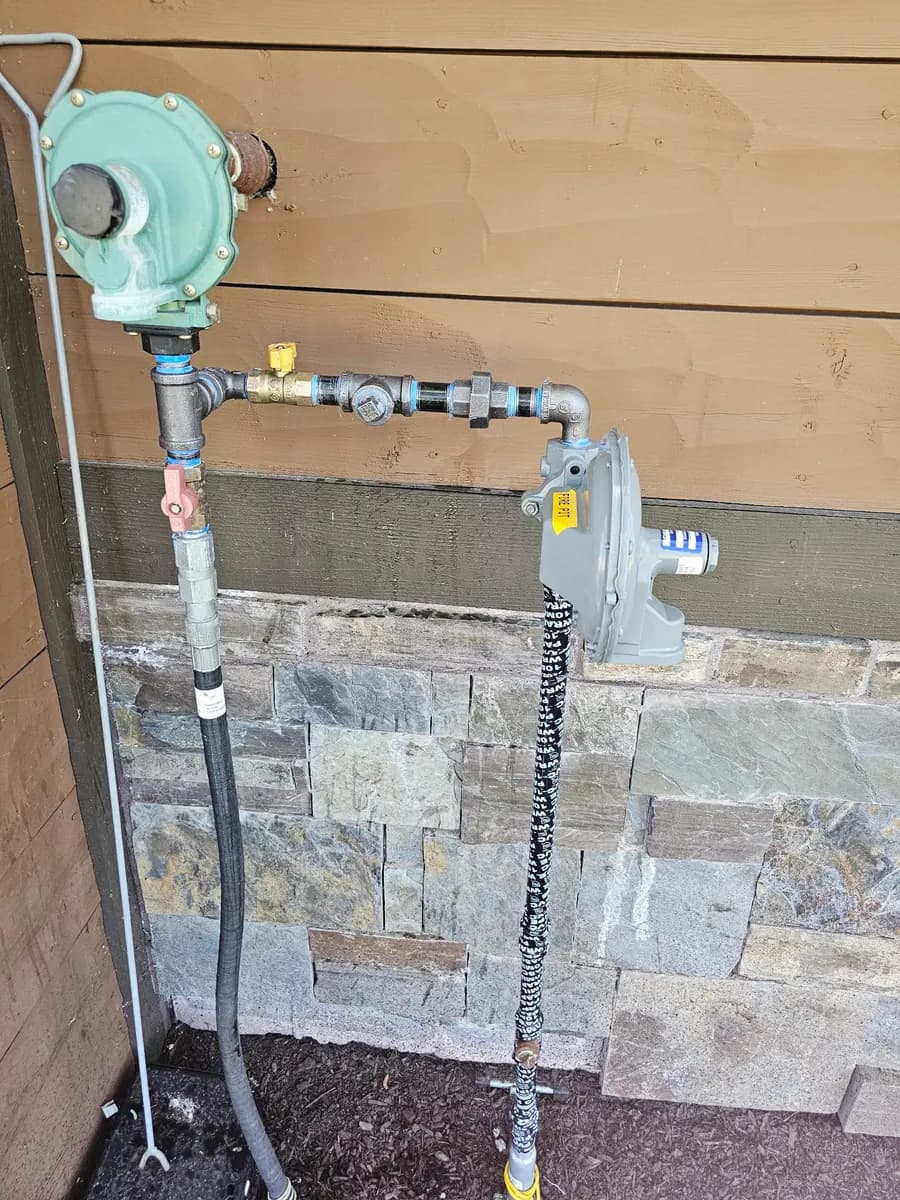Gas line routed through a stone wall for outdoor equipment